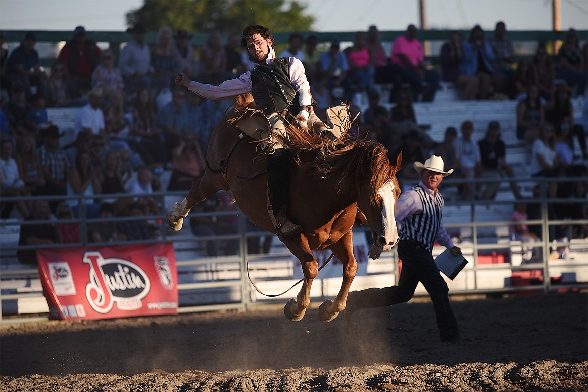 Dusty Morigeau, from Kalispell, rides Guardian Angel during bareback riding at the Northwest Montana Fair & Rodeo on Saturday, Aug. 22. (Casey Kreider/Daily Inter Lake)