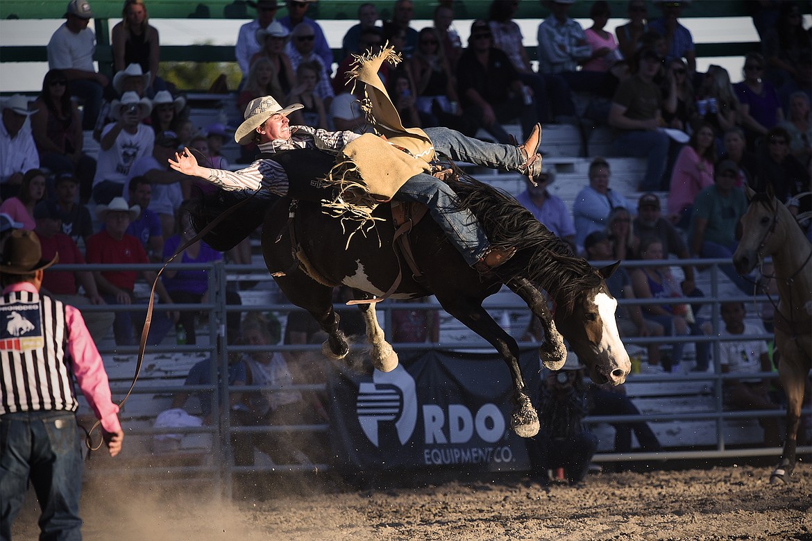 Troy Kirkpatrick, from Wise River, Montana, rides High Rolling Sidney during bareback riding at the Northwest Montana Fair & Rodeo on Saturday, Aug. 22. (Casey Kreider/Daily Inter Lake)
