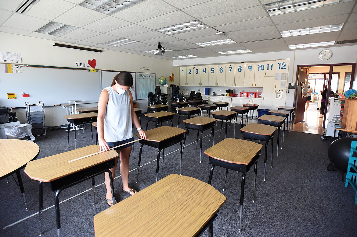 Halle Fusaro, a fourth-grade teacher at Edgerton Elementary School, measures the space between desks in her classroom on Thursday, Aug. 20. (Casey Kreider/Daily Inter Lake)