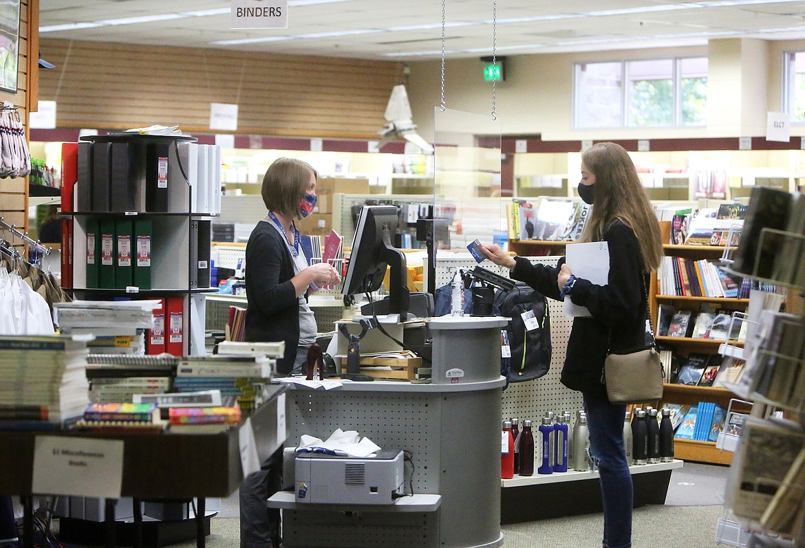 Kendall Pyron, an education student from Kalispell, buys books from Dawn Steele at the FVCC bookstore on Monday, Aug. 24. (Mackenzie Reiss/Daily Inter Lake)