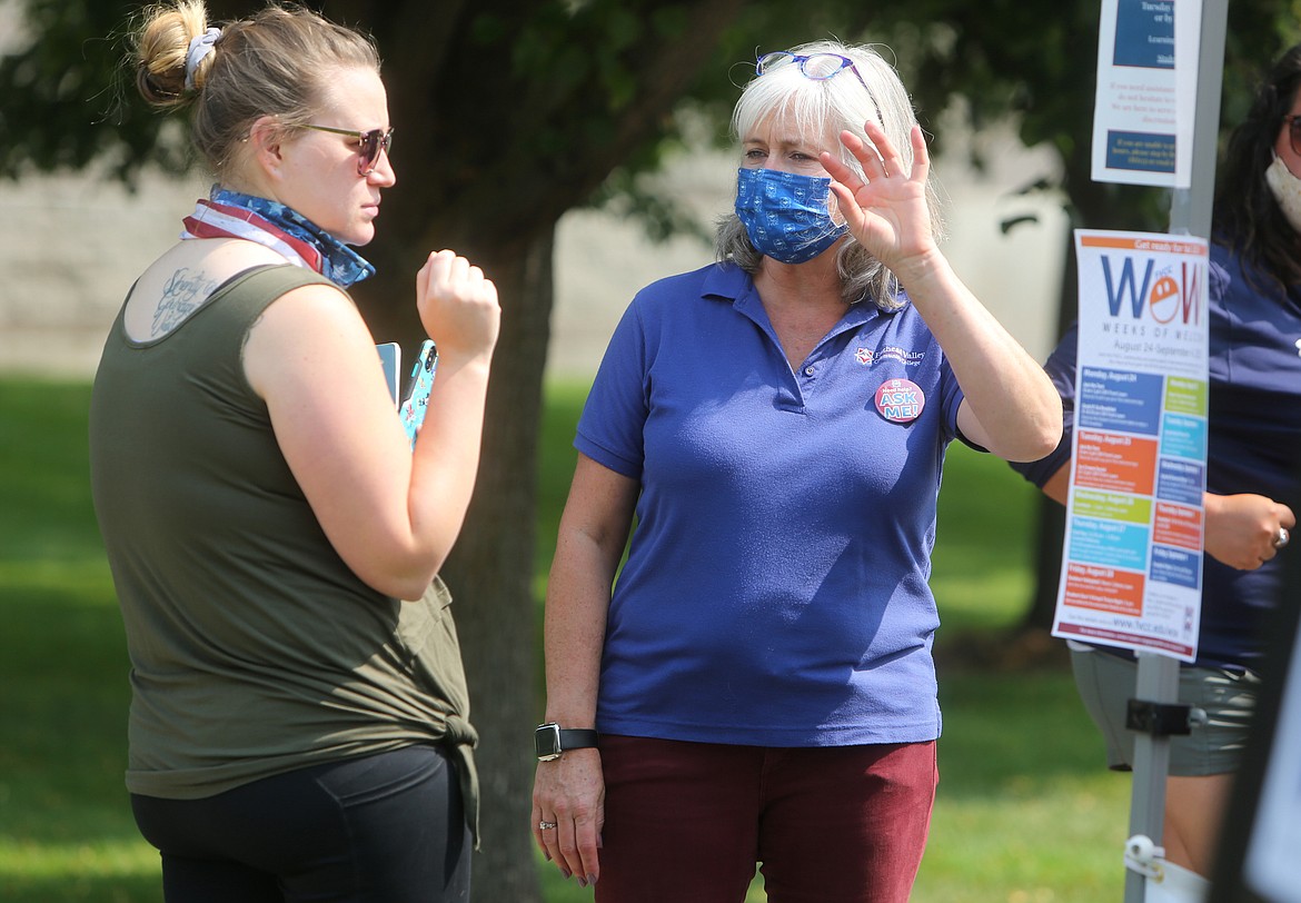 Student engagement coordinator Wendy Jeschke answers a question from pre-nursing student Rachel Dunegan, of Kalispell. (Mackenzie Reiss/Daily Inter Lake)