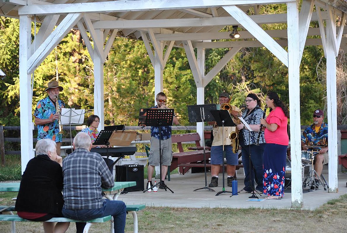 Behind the perfect shade of the Old Deborgia Schoolhouse a small smattering of an audience toe-tapped and enjoyed the tunes from the informal Mineral County Dixieland Band. Vern and Bonnie Rusk had a picnic table to themselves on the evening of August 20 at the impromptu outdoor music gathering. Band members from left to right, Chris Martineau on soprano sax, Dawn Hammerstein on the keyboard, Derek Larson played trumpet, Denley Loge slid the trombone, Shelly Larson on the saxophone, Amber Winter played clarinet, and Matt Eisenbacher kept the beat on the drums. (Amy Quinlivan/Mineral Independent)