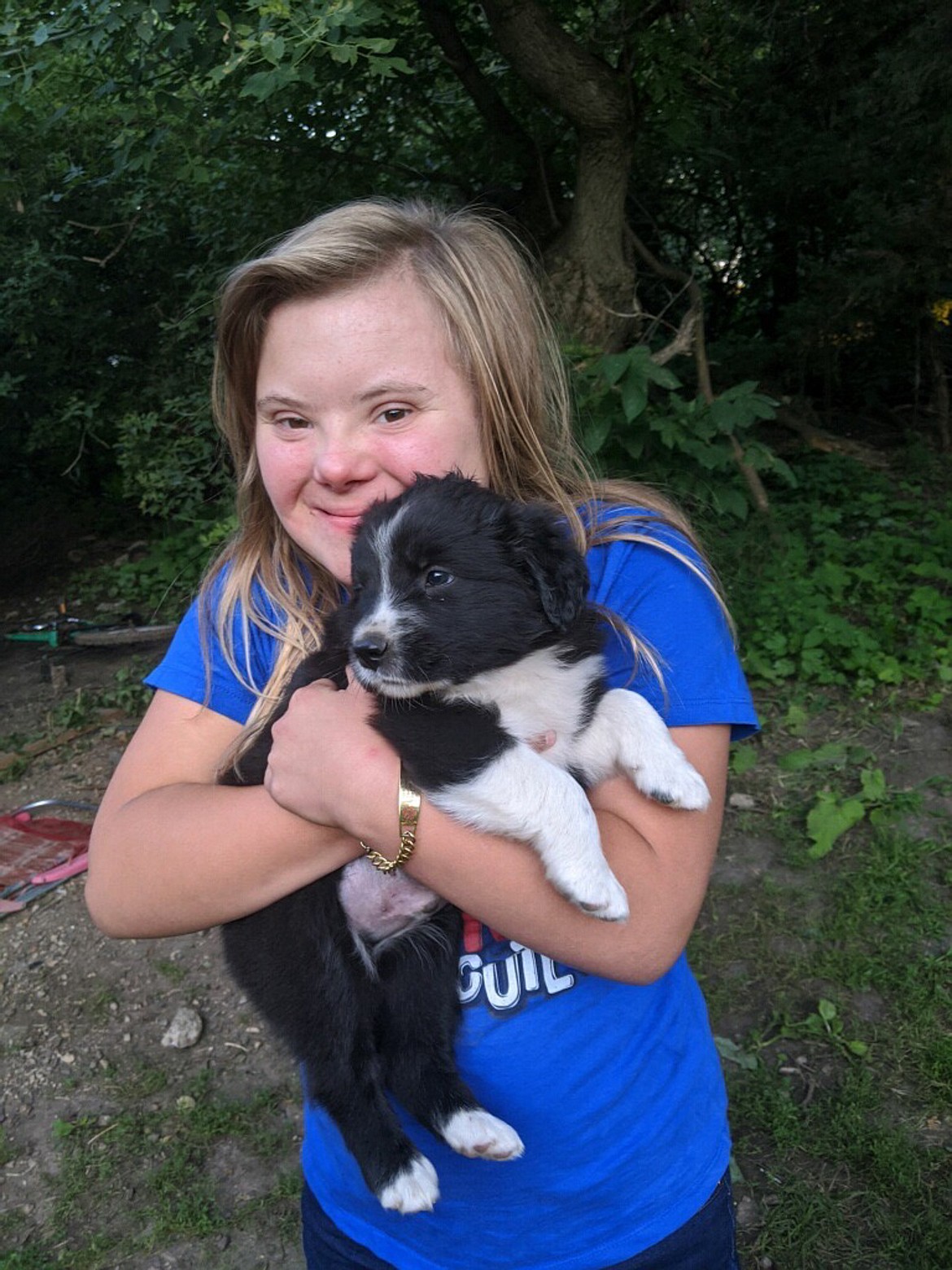 Courtesy photo
Benita Ketola grins from ear to ear holding a puppy on a trip to South Dakota. Ketola’s smile was ear-to-ear as well when her mother, Denise Ketola, told her she’d get to ride the bus again soon with school starting back up.