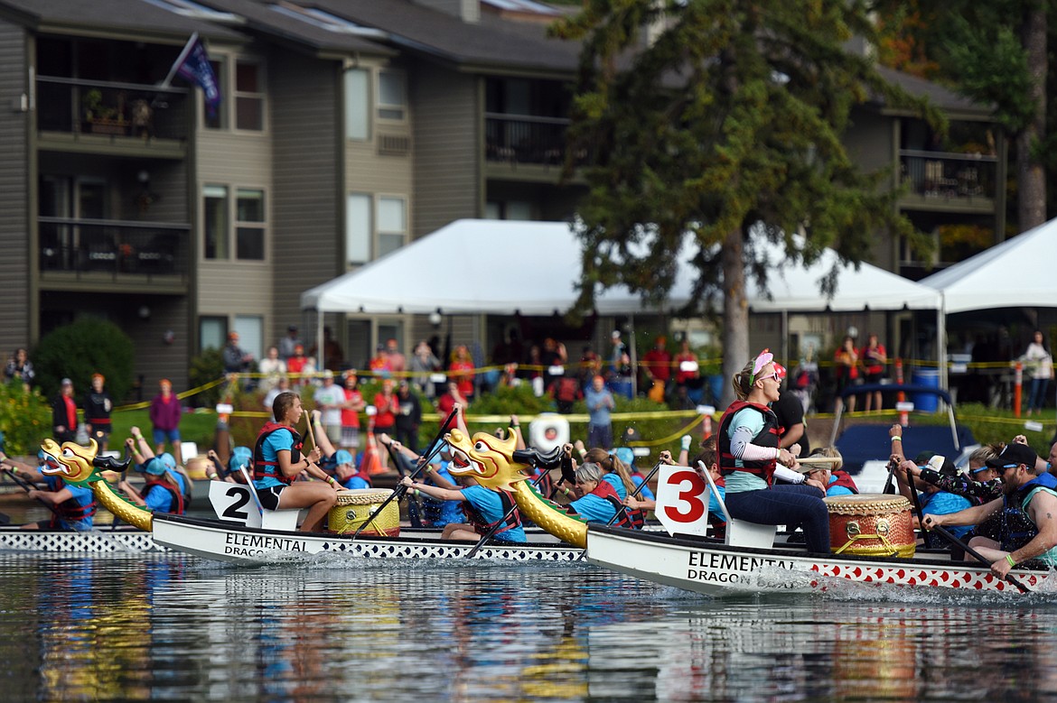 $ID/NormalParagraphStyle:The Aloha Paddlers and the Healing Dragons race toward the finish line in their heat at the 2019 Montana Dragon Boat Festival in Bigfork Bay in 2019.