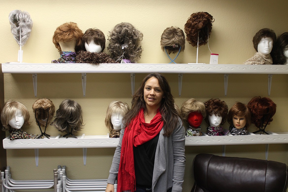 Angel Ledesma in 2015 showing off some of the wigs that the Columbia Basin Cancer Foundation helps get to local patients experiencing hair loss, a common side effect of certain forms of cancer treatment.