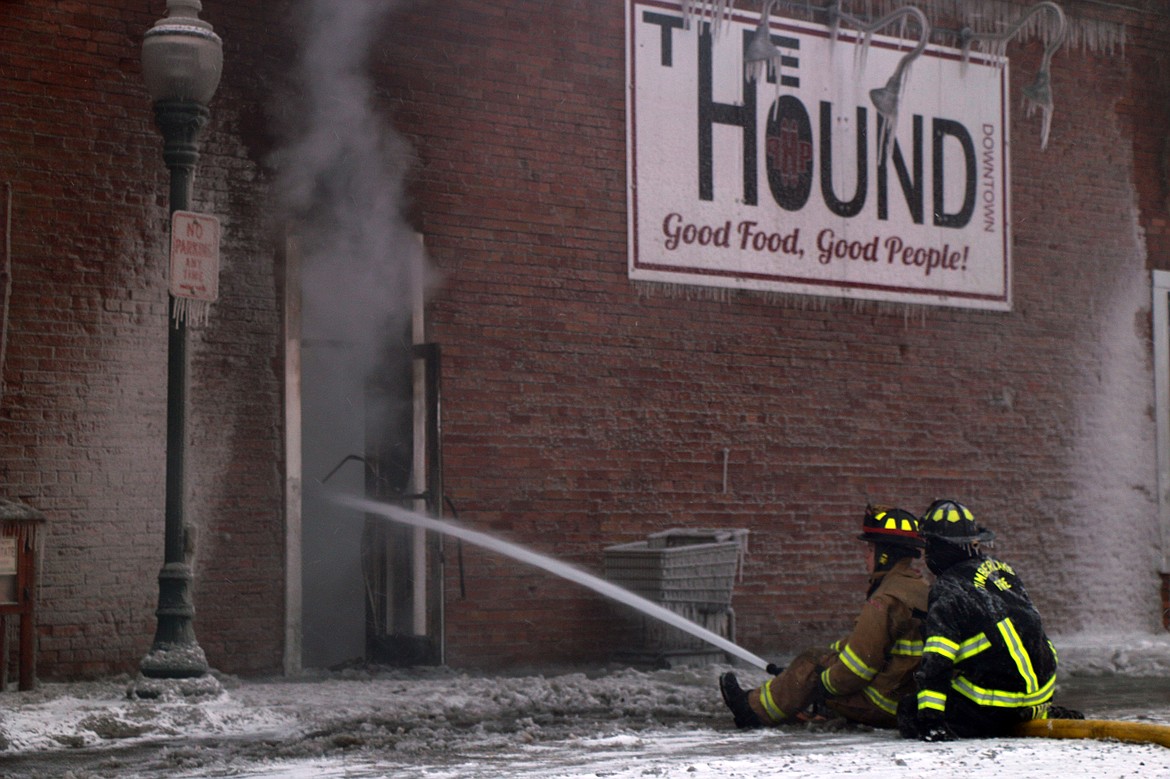 (File photo/CAROLINE LOBSINGER)
Area firefighters direct water into The Hound as they mop up at the scene of a Monday fire in Sandpoint’s Historic District.