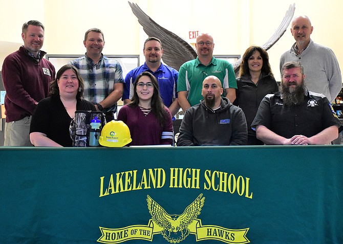 Lakeland High senior Veronika Aviles will be employed at Idaho Forest Group's Chilco mill while attending college. Front row from left: Alicia Aviles, Veronika's mother; Veronika; Matt Aviles, Veronika's father; and Corey Pettit, Lakeland's industrial mechanics teacher. Bac row: Colby Mattila, Kootenai Technical Education Campus principal; Charlie Jackman, IFG; Mike Henley, IFG; Marie Price, IFG; and Trent Derrick, Lakeland principal. (Courtesy photo)
