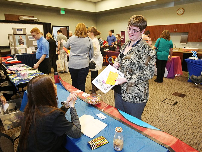 Emily Hollis chats with Roger's Ice Cream General Manager Amber McIlreavy during the inaugural Discovery Job Fair in early May. (LOREN BENOIT/Press)