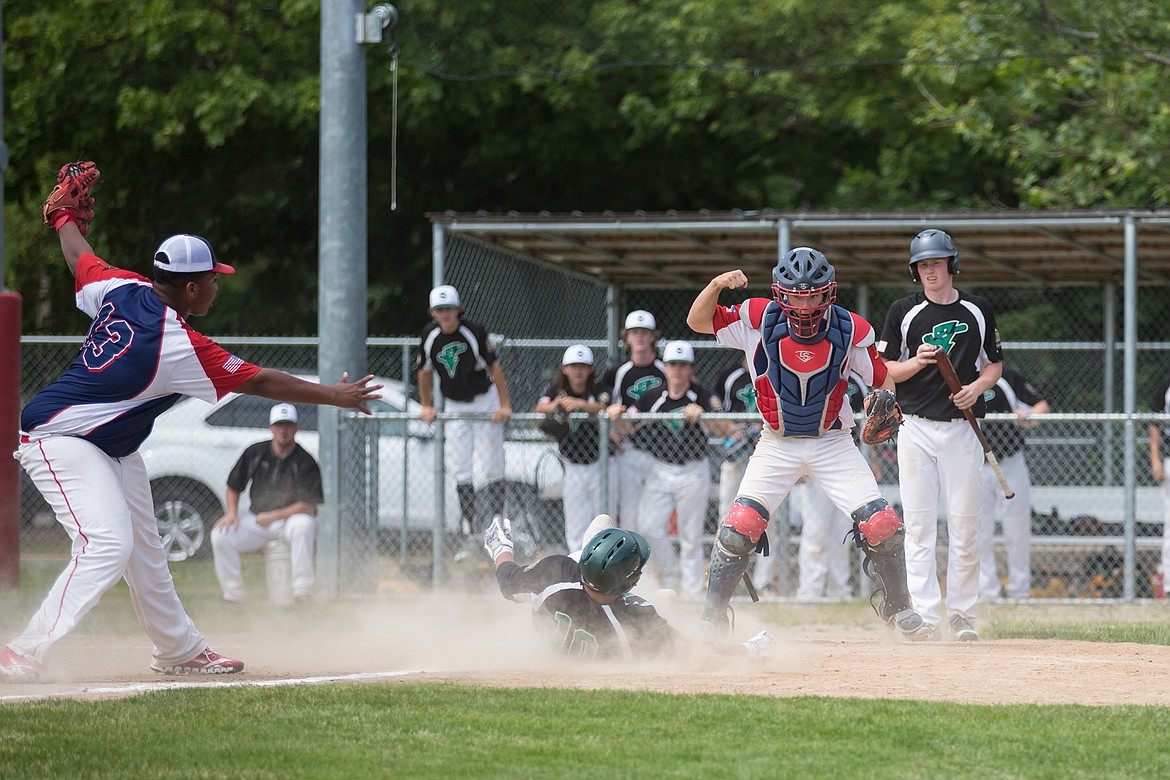 North Idaho Lakers Tyrone Larson (left) and Tom Riley (right) celebrate after recording an out at home plate against the Shadle Park Shockers during the 2018 Beach Wood Bat Tournament Championship game on June 17, 2018.