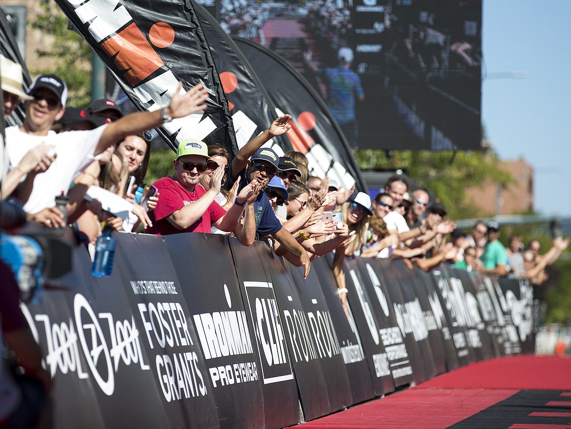 The crowd cheers on first place overall Ironman Coeur d'Alene athlete Mark Saroni in 2018. (LOREN BENOIT/Press file)