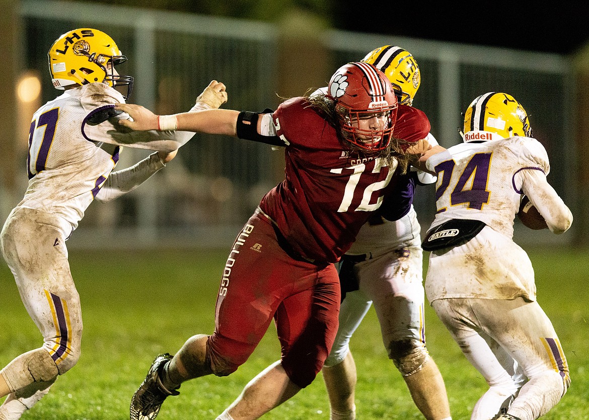 (Photo courtesy of JASON DUCHOW PHOTOGRAPHY) 
 Keith Jensen breaks through a double team by the Lewiston offense last season. Jensen, a senior captain, wants to wreak havoc on the defensive line this season and is aiming for five sacks and 40 tackles.