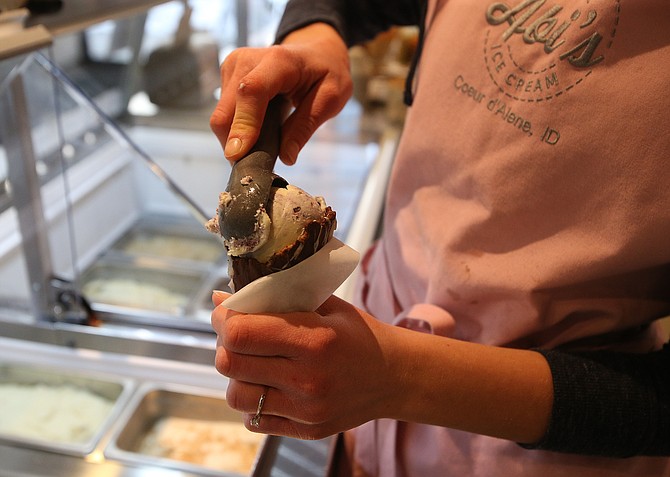 Grace Meyer makes a blueberry cheesecake ice cream cone for a customer at Abi’s Ice Cream.