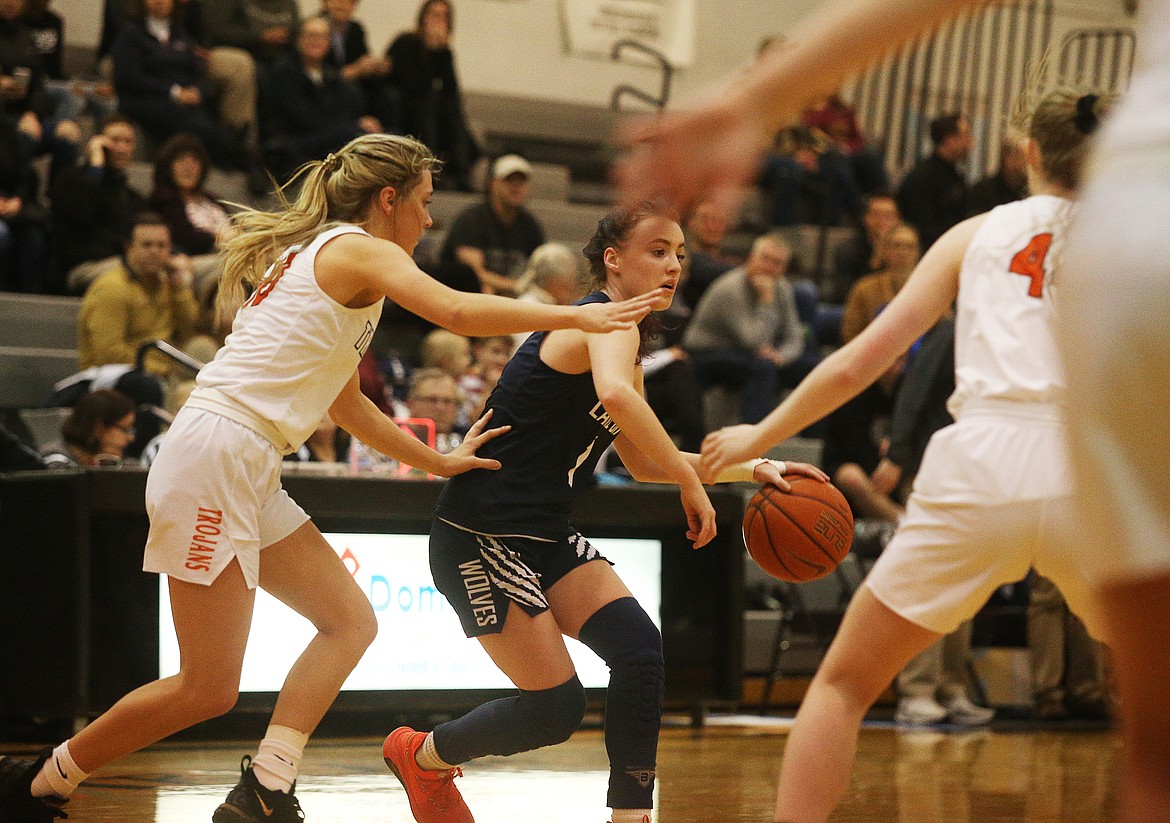 Lake City’s Aubrey Avery dribbles the ball around the arc while defended by Post Falls’ Dylan Lovett during Friday night’s game at Post Falls High.