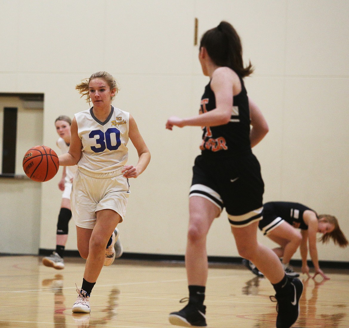 North Idaho Christian guard Kate Malinaukas dribbles the ball down the court in a game against Priest River last Wednesday.