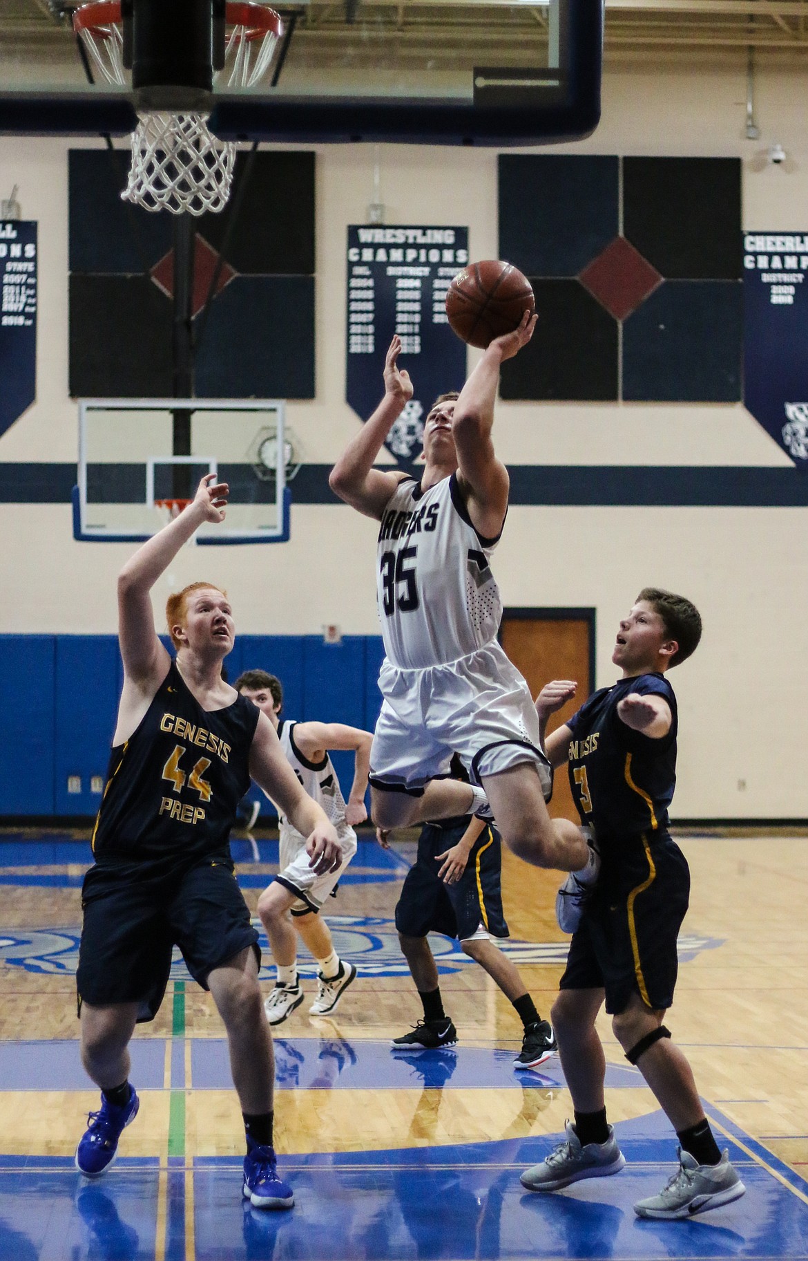 Photo by MANDI BATEMAN 
 Matt Morgan drives past opponents in last Friday's game against Genesis Preparatory Academy.