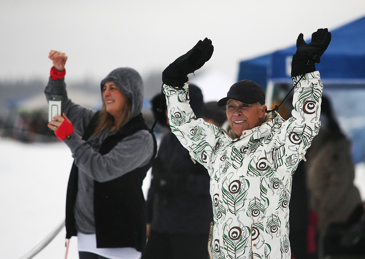Mother Kara Williams, left, and grandmother Pam Hill cheer for Beau Williams, 6, during a Priest Lake Vintage Snowmobile Race Saturday.