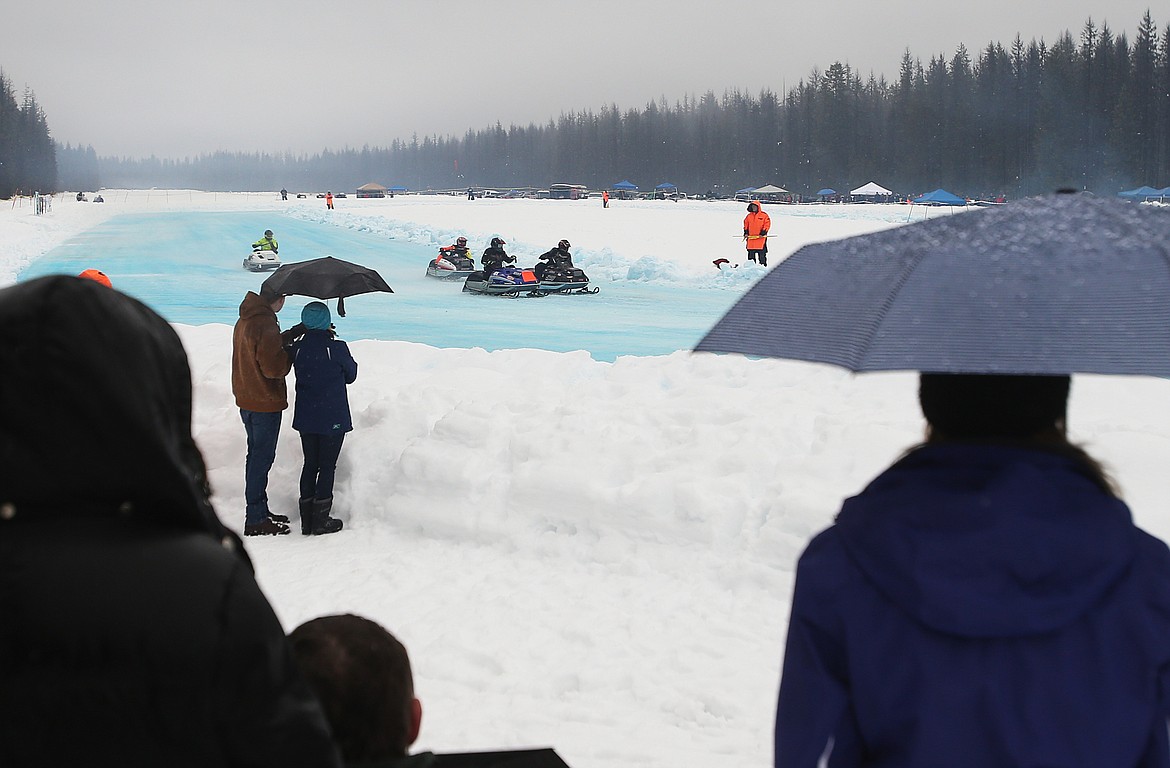 Spectators brave the weather to watch the Priest Lake Vintage Snowmobile Race on Saturday.