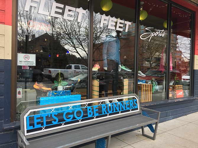 A bench in front of Fleet Feet invites passersby to sit down or run.