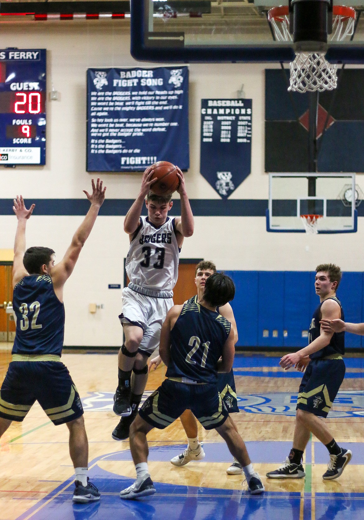 Photo by MANDI BATEMAN 
 Braeden Blackmore leaps through a hole between defenders on his way to the basket.