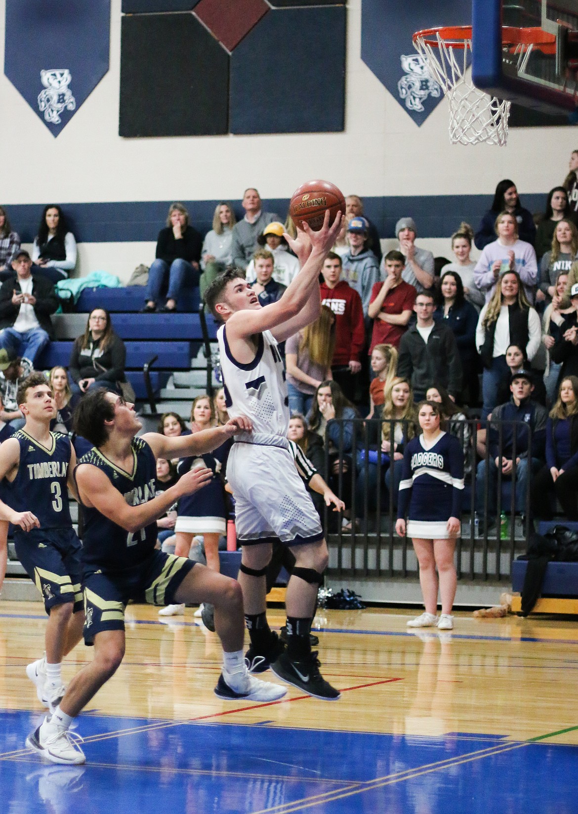 Photo by MANDI BATEMAN 
 Braeden Blackmore rises for a dunk shot against Timberlake.