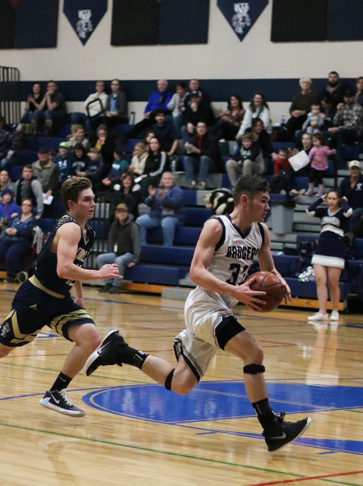 Photo by MANDI BATEMAN 
 Braeden Blackmore races down court ahead of the Timberlake players.