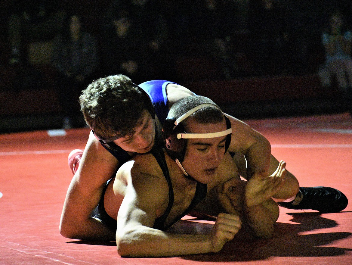 Sandpoint senior Brady Nelsen (bottom) battles Coeur d’Alene’s Drew Roberts in a dual at Les Rogers Court on Jan. 23. Nelsen, Heather Wallace and Matt Thurlow all placed at the North Idaho Rumble on Saturday.