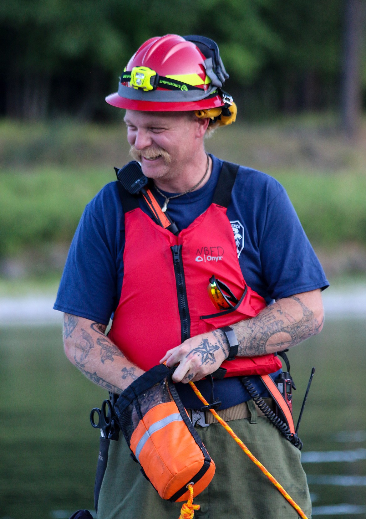 North Bench Firefighter Tom Chaney, known for always having a smile on his face, takes part in river rescue training.