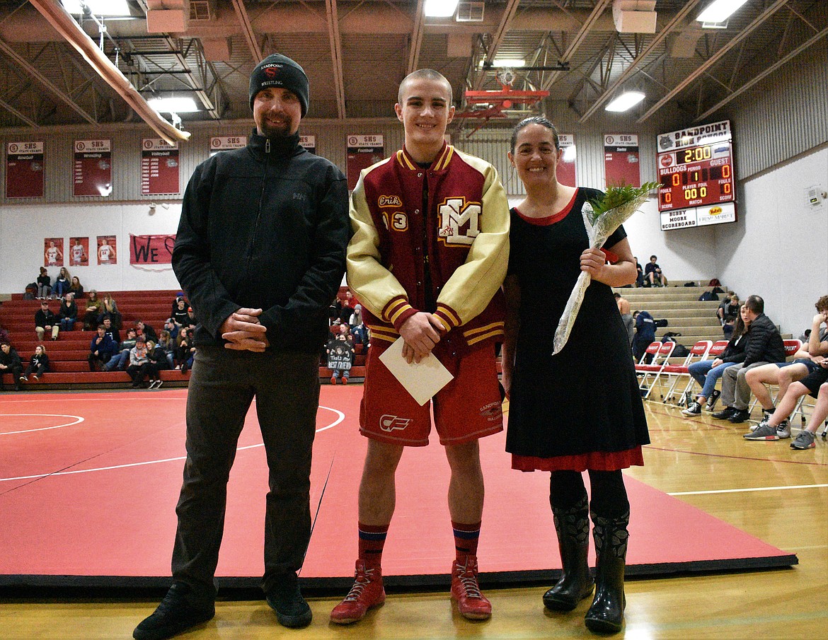 (Photo by DYLAN GREENE) 
 Brady Nelsen celebrates senior night with his family.