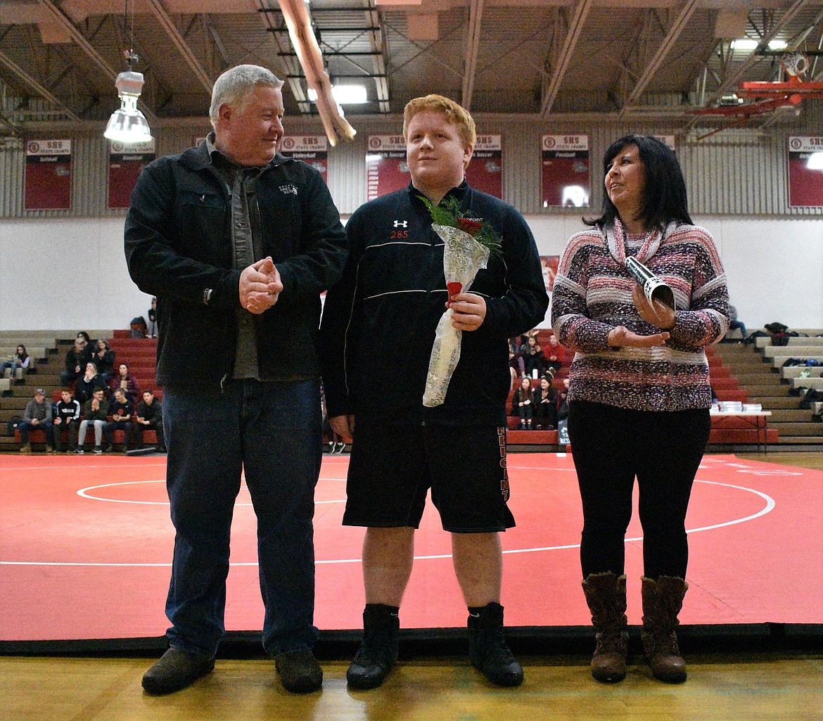 (Photo by DYLAN GREENE) 
 Evan Twineham celebrates senior night with his family.