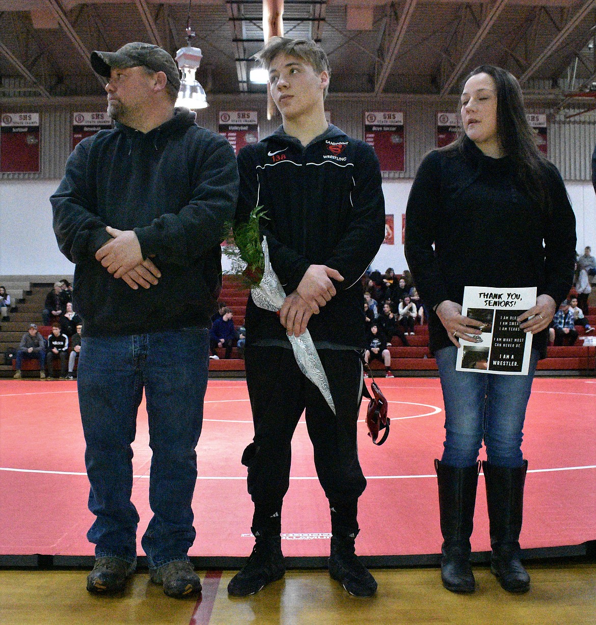 (Photo by DYLAN GREENE) 
 Malachi Fleck celebrates senior night with his family.