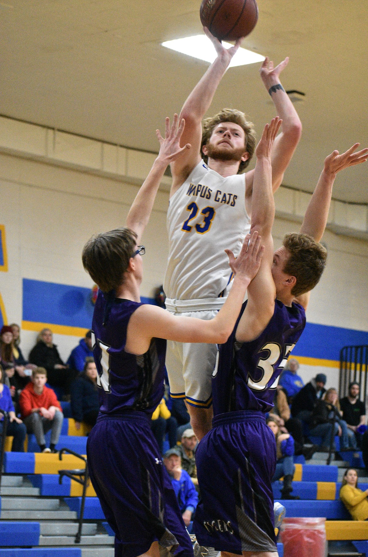 (Photo by DYLAN GREENE) 
 Senior Josh Constantin puts up a shot over a pair of Mullan defenders on Thursday.