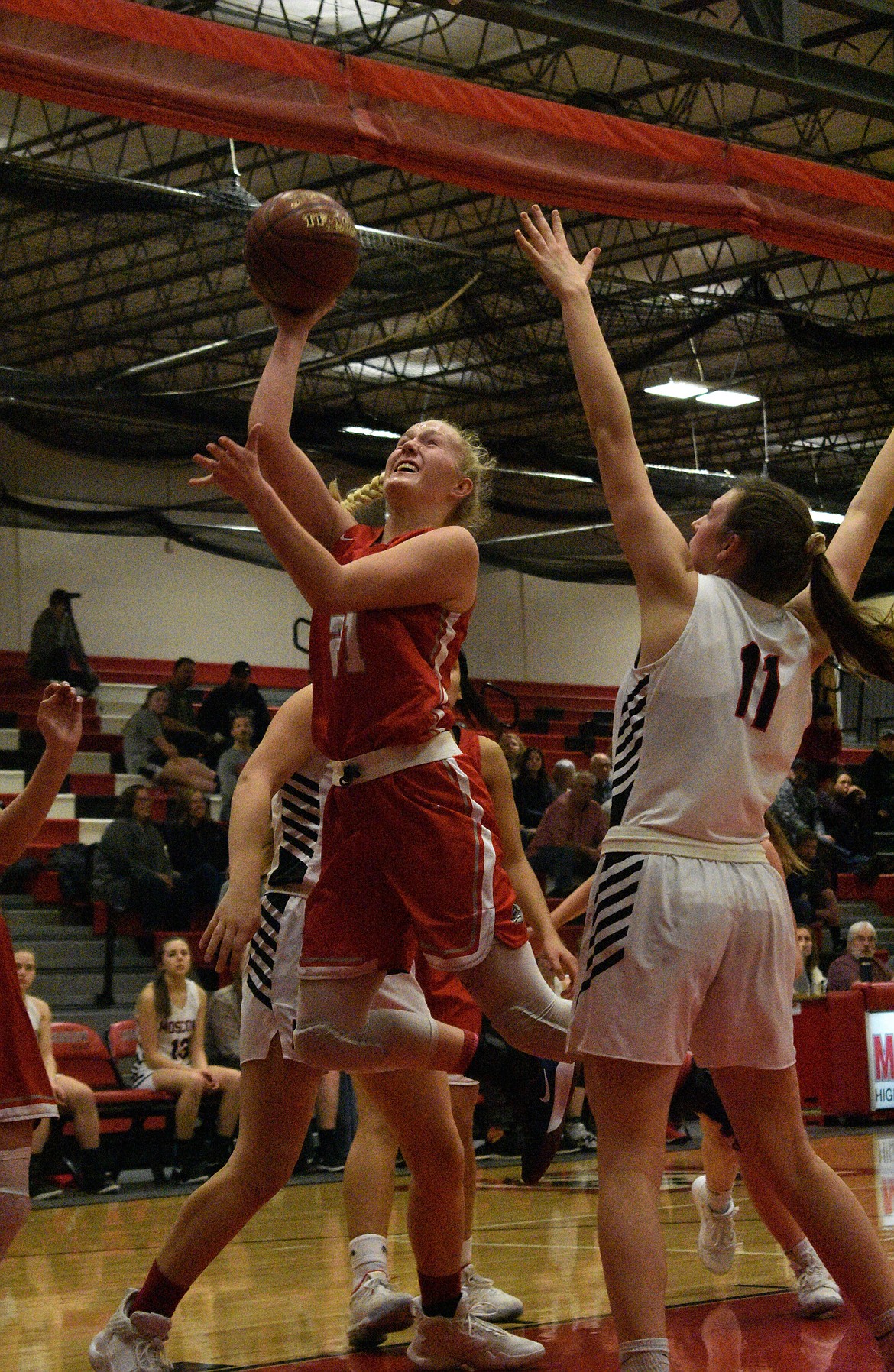 Junior Hattie Larson splits through the Moscow defense to put up a shot last Saturday at the Bear Den. The Bulldogs won the game 41-34.