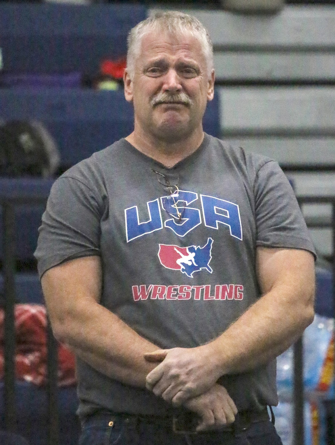 An emotional Conrad Garner looks on as nearly the entire Bonners Ferry High School gym stands to salute his dedication as a coach, teacher and administrator. Garner, who is retiring in July, was honored in a surprise ceremony during a wrestling meet on Friday, Feb. 7.