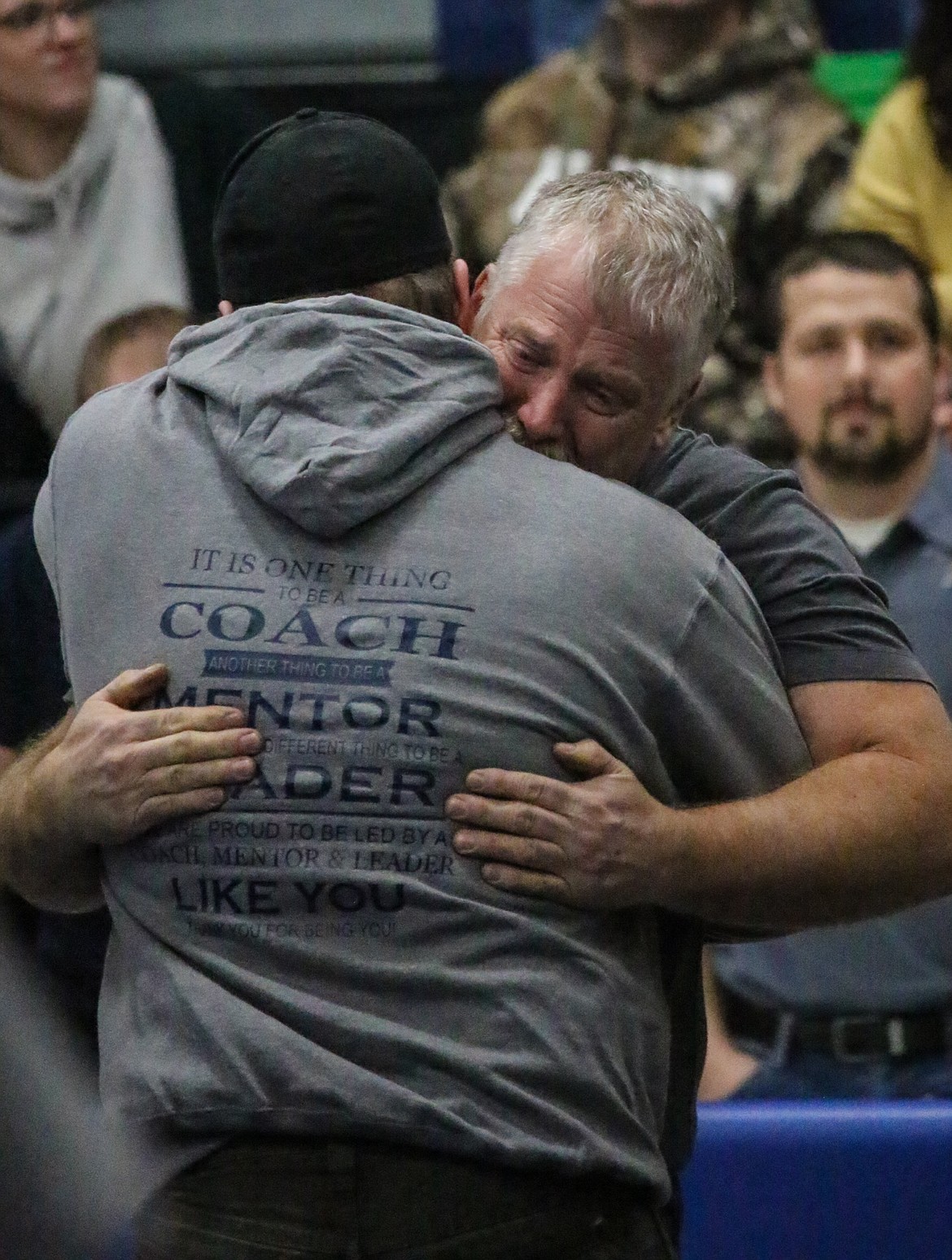 Photo by MANDI BATEMAN 
 People waited to hug Conrad garner at the end of the event, many wearing custom Team Garner shirts.