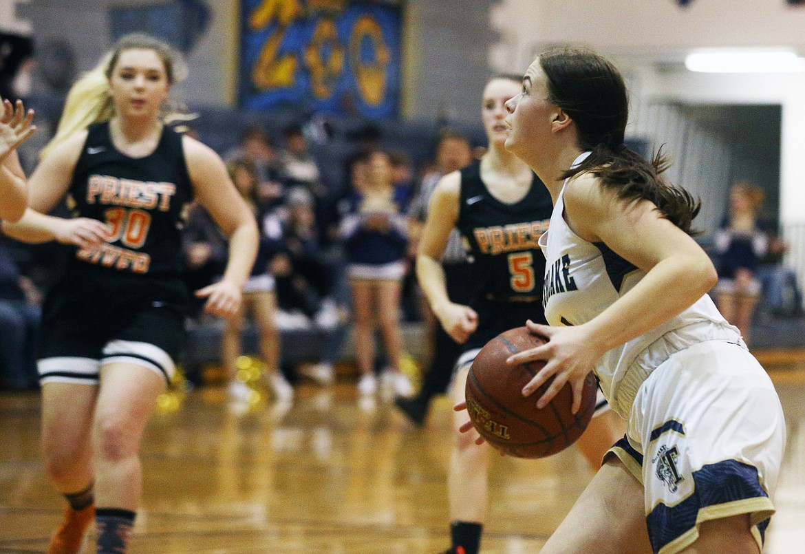 Timberlake’s Bernie Carhart drives to the basket against Priest River.