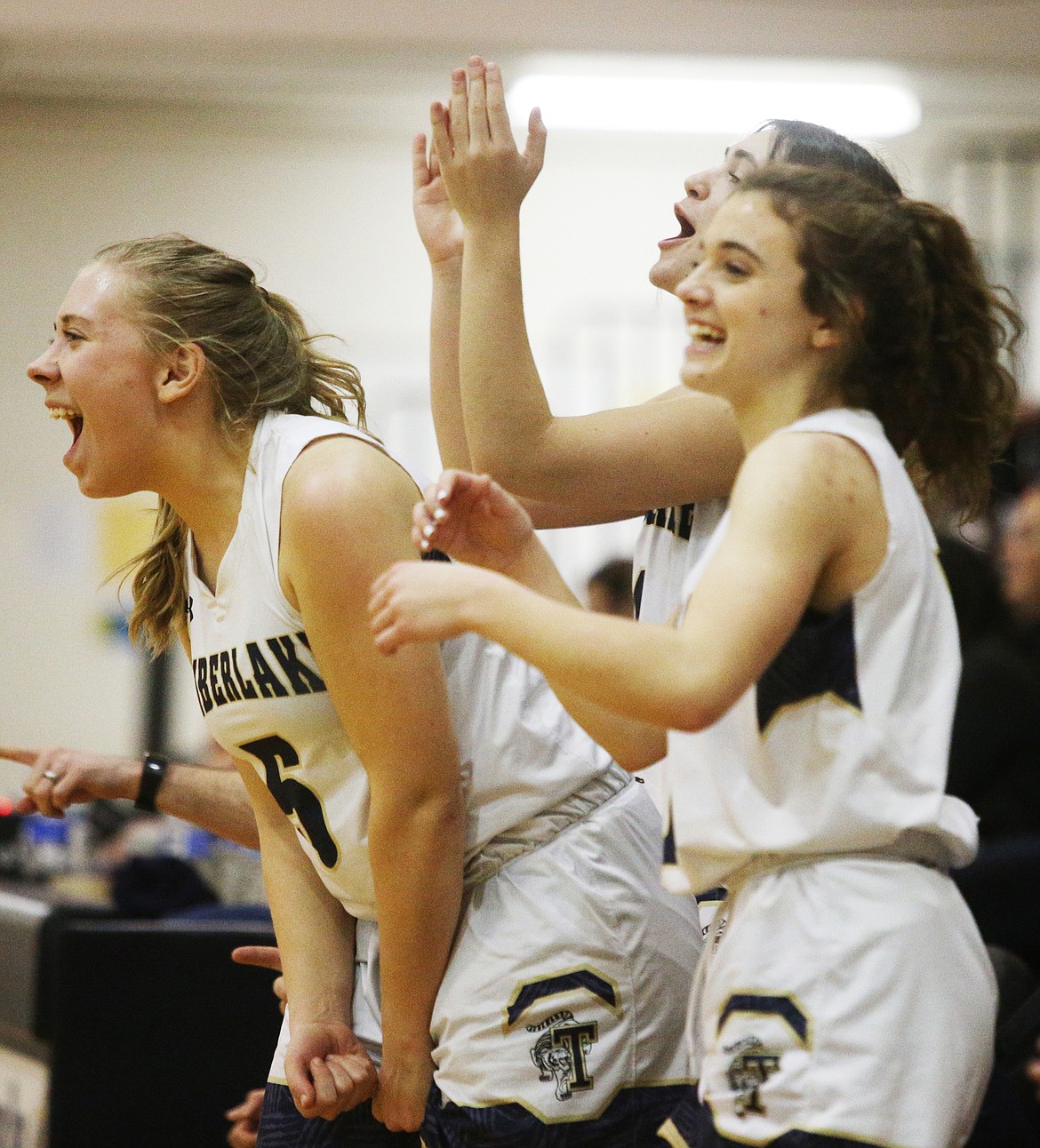 The Timberlake High School girls basketball bench erupts after a 3-pointer against Priest River.