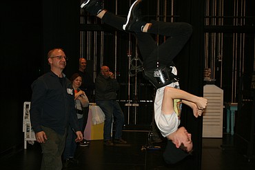 Taylor Street (upside down), cast as Bert, gets a lesson in acrobatics from flying director Mark Kostuch (left). The Quincy Valley Allied Arts production of “Mary Poppins” opens Feb. 20.