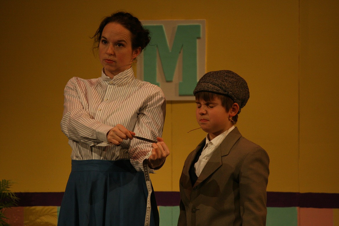 Cheryl Schweizer/Columbia Basin Herald | Michael Banks (Lev Rosberg, right) doesn’t like what Mary Poppins’ (Stephanie Moore) measuring tape has to say in the Quincy Valley Allied Arts production.