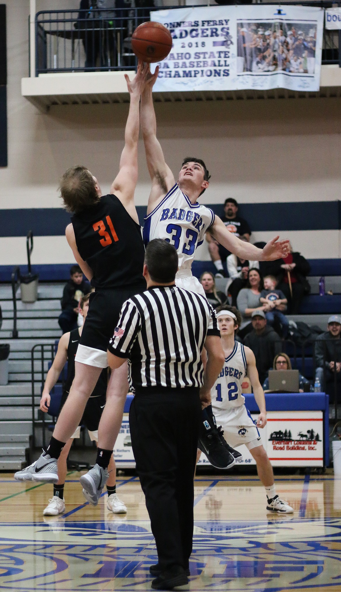 Photo by MANDI BATEMAN 
 Braeden Blackmore jumping high for the tip off.