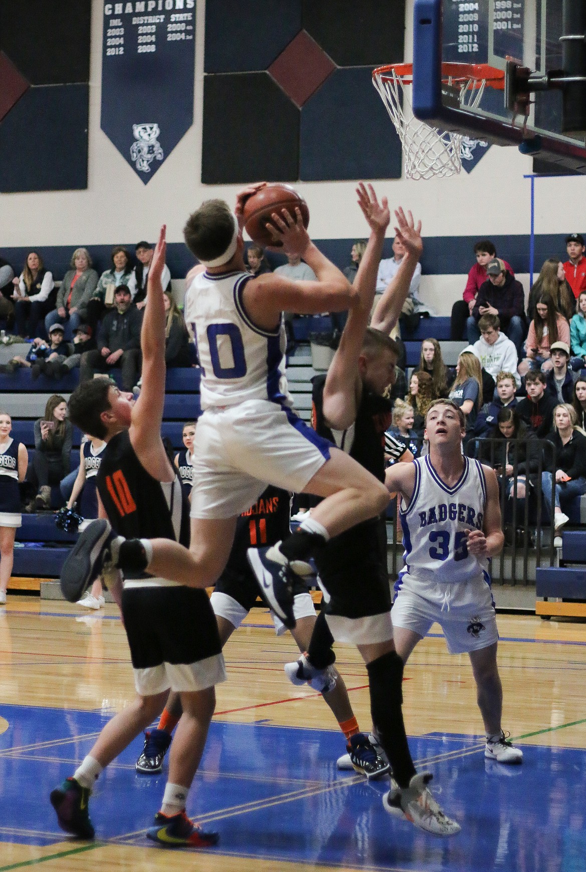 Photo by MANDI BATEMAN 
 Ty Bateman drives to the basket on senior night.