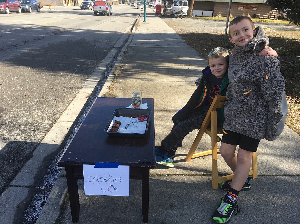 Brothers Jatta, right, and Ira Loomis sell brownies on Sherman Avenue on Monday afternoon. Due to the Presidents Day holiday, the boy decided to earn money by making and selling the treats.