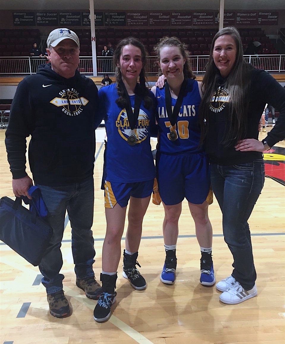 Clark Fork assistant coach Mark Stevens (left), Sara Hathaway, Ellie Kiebert and head coach Jordan Adams pose for a photo after the two seniors received North Star League honors last Thursday.