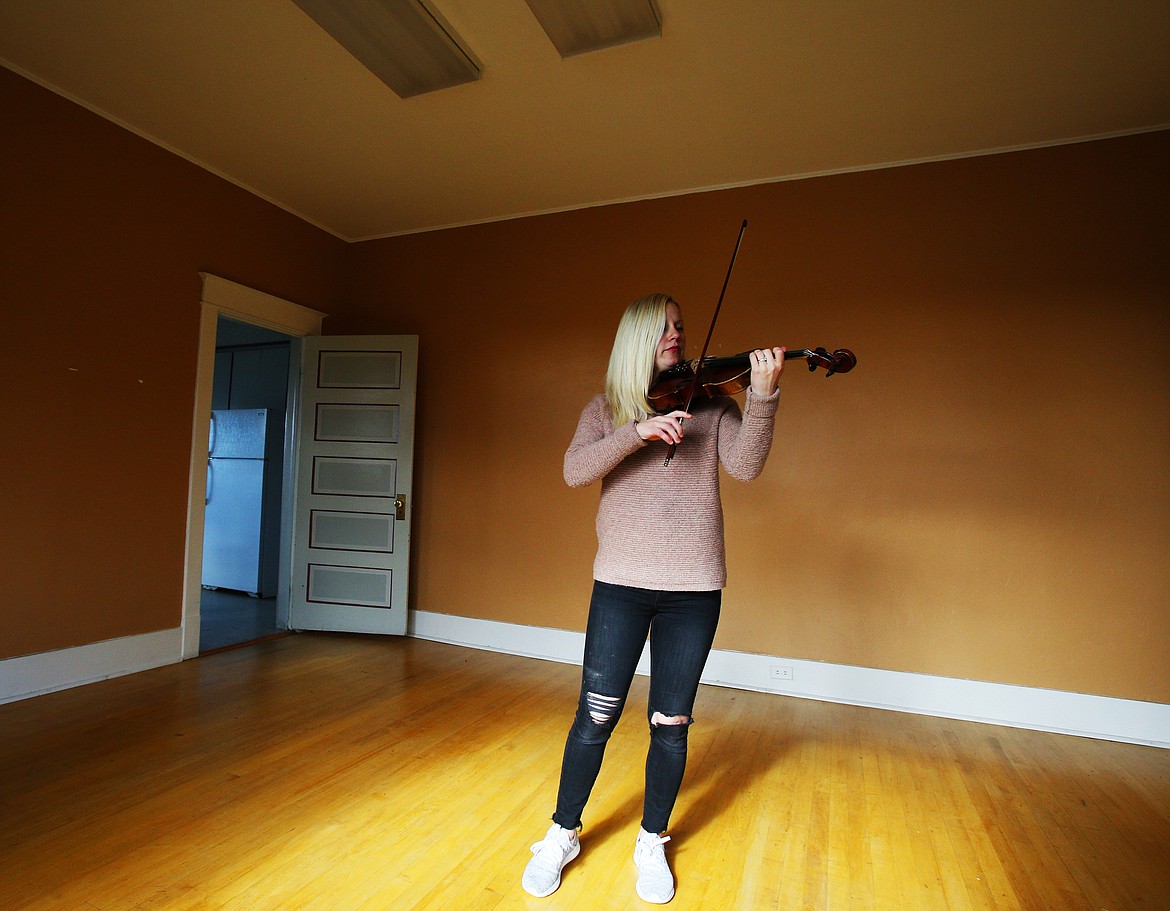 Maria Dance Clayton plays the violin in the old dining room of the old Romer house off Government Way. Maria’s mother, Julienne Dance, aims to start a music conservatory for youth and adult lessons a