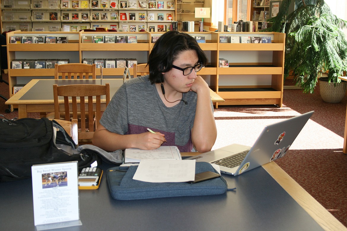Cheryl Schweizer/Columbia Basin Herald 
  
 Big Bend Community College student Alejandro Vizcarra works on an assignment in the BBCC library Tuesday. The college's enrollment has increased between wi