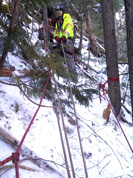 Photo by GARRY WRIGHT 
 Hall Mountain Firefighter, Matt Cossalman, with the ropes set up to rescue the stranded dog.