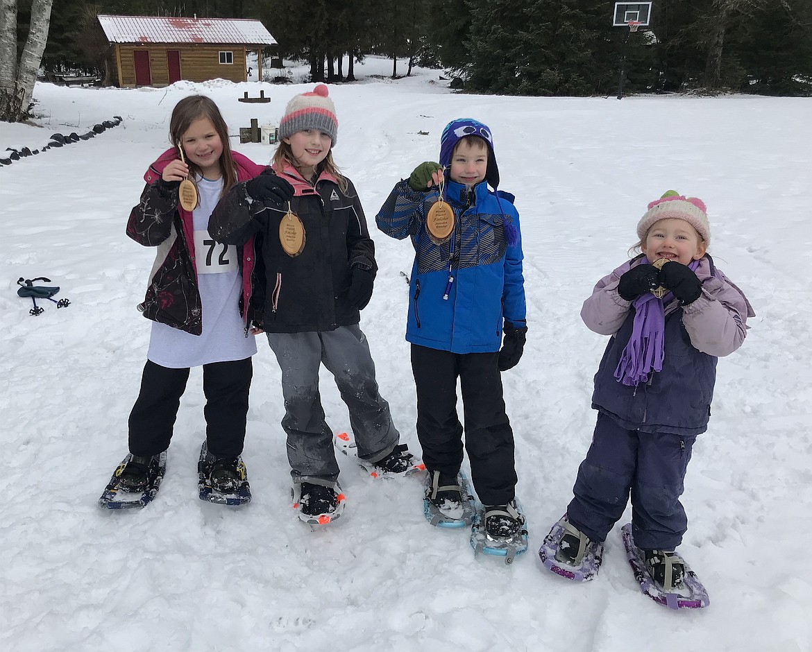 Four youngsters who participated in the Buckaroo race at the seventh annual Western Pleasure Snowshoe Roundup on Feb. 8 pose for a photo after completing the course.