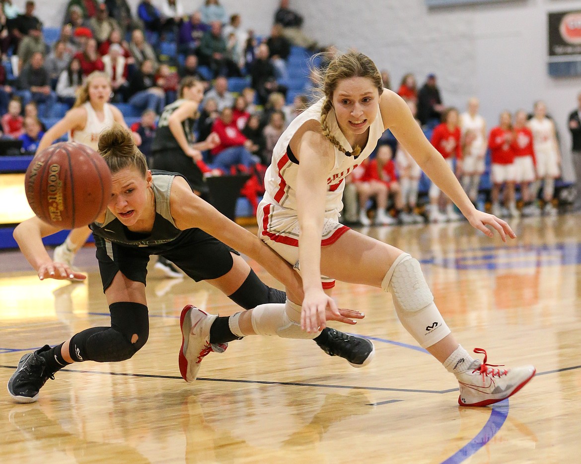 (Photo courtesy of JASON DUCHOW PHOTOGRAPHY) 
 Senior Dawson Driggs battles a Burley player for possession of the ball during the Bulldogs opening game at the 4A state tournament on Feb. 20. Driggs is a finalist for the 5A-4A girls basketball award.