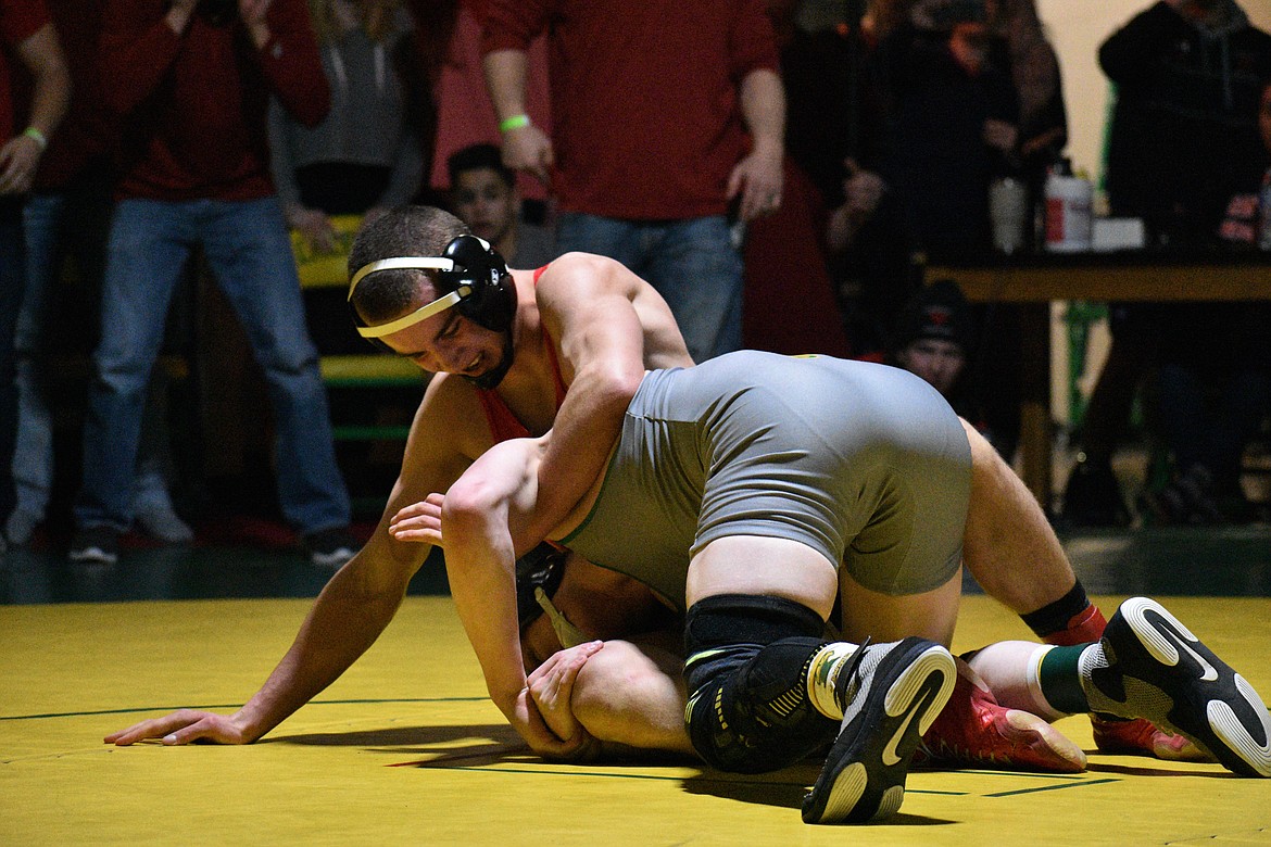 (Photo by DYLAN GREENE) 
 Sandpoint senior Brady Nelsen (left) attempts to score points in the closing seconds of the 145-pound championship match Saturday at Lakeland High.