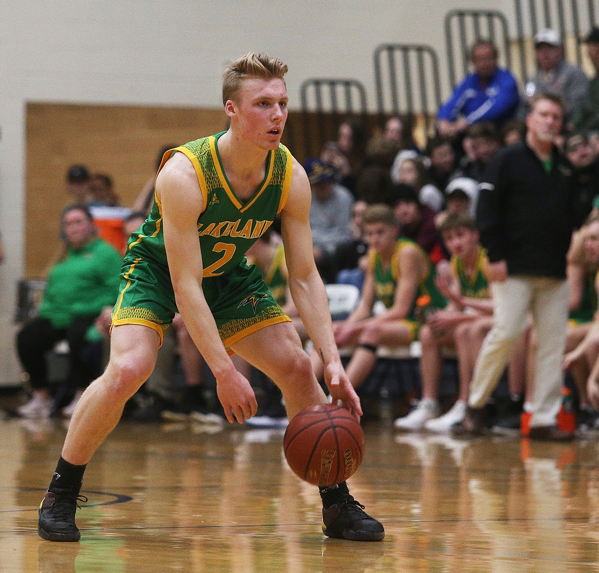 Lakeland’s Ben Zubaly dribbles the ball at the top of the key in a game at Lake City.