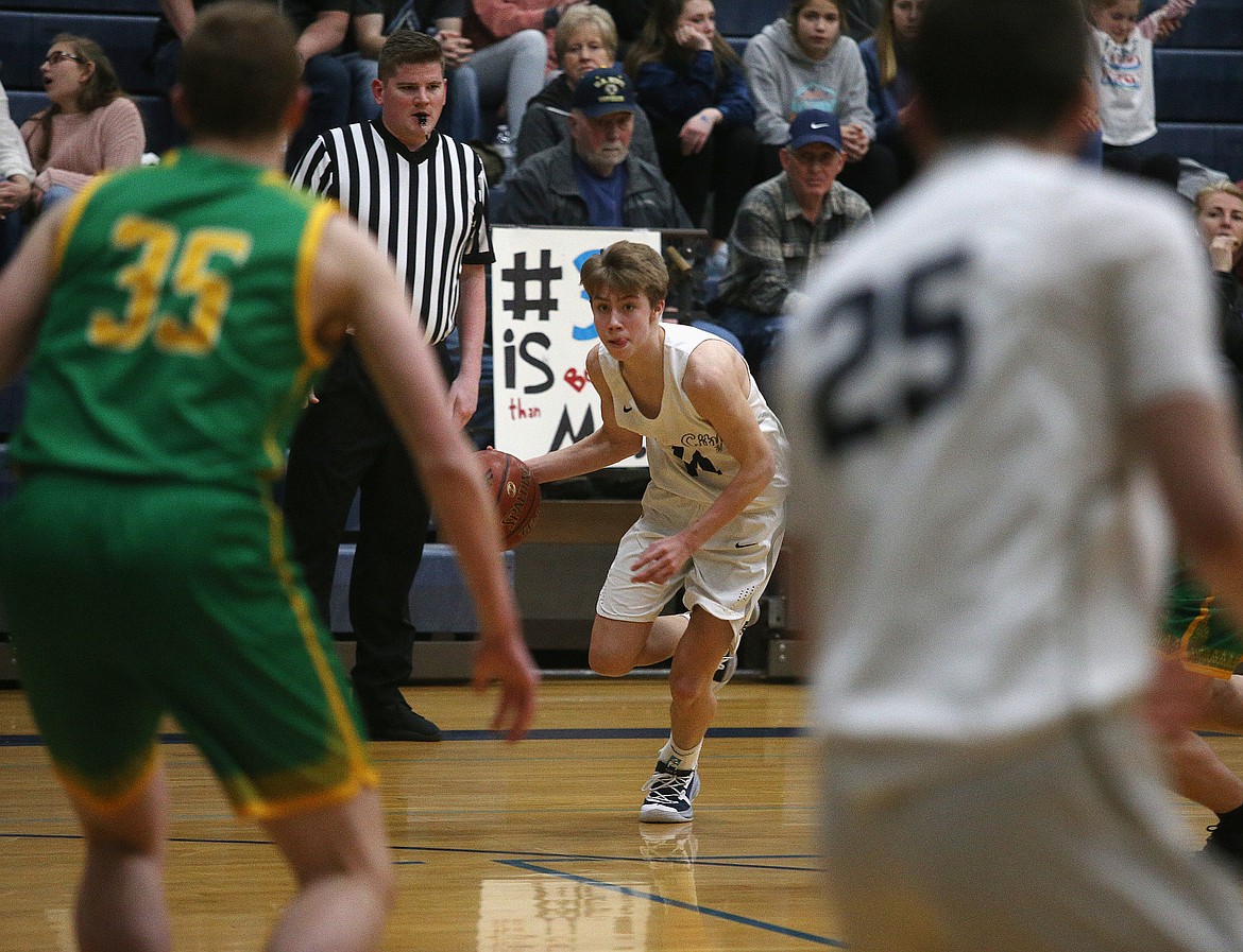 Lake City’s Kolton Mitchell eyes Lakeland’s defense as he dribbles the basketball during a game last Tuesday at Lake City.